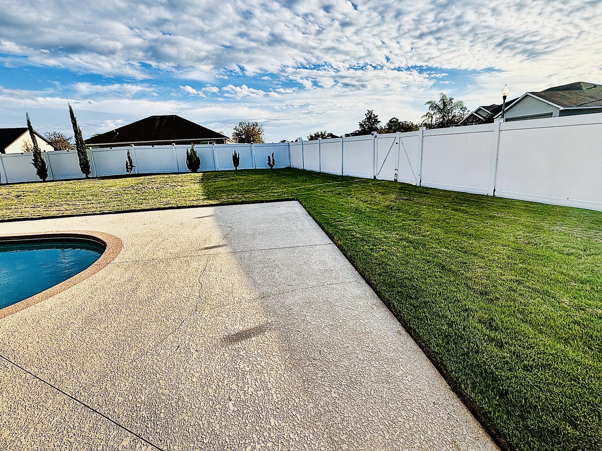 Backyard pool area lawn maintenance